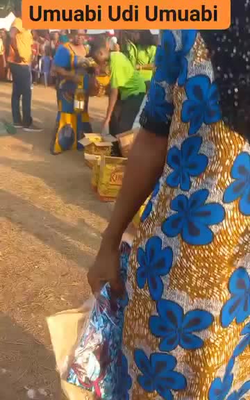 A volunteer hands supplies to a community member at the Darlstina Foundation giveaway